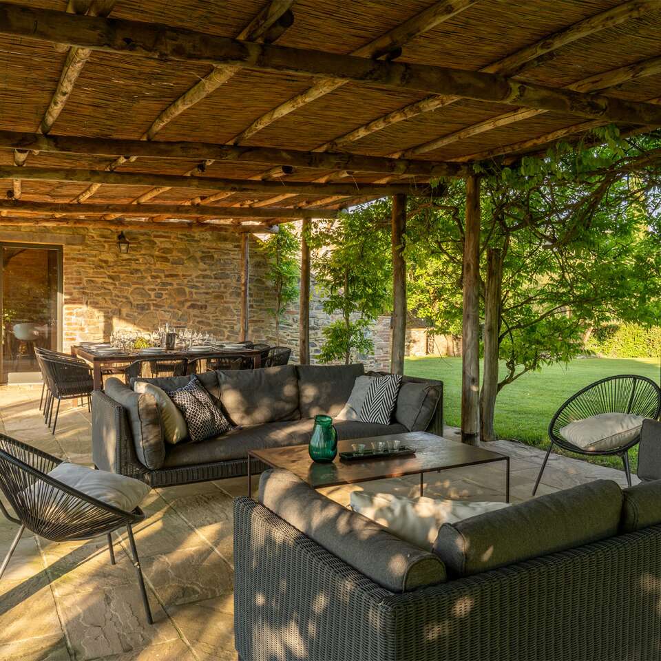 covered al fresco dining surrounded by majestic garden